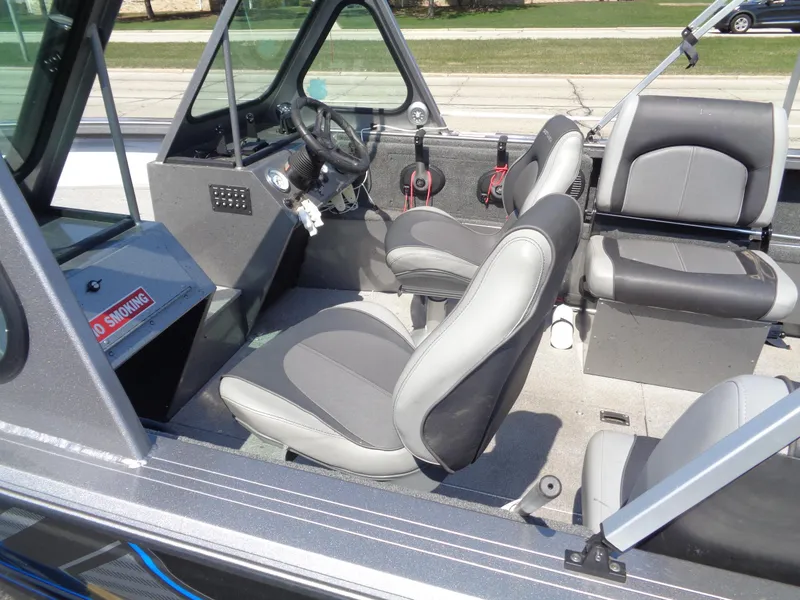 Slide: The Image of 2017 Crestliner CCM185 boat interior with gray seating and steering console. - 7
