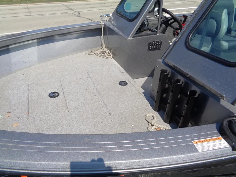 Slide: The Image of 2017 Crestliner CCM185 boat interior with steering wheel, seating, and storage compartments. - 8