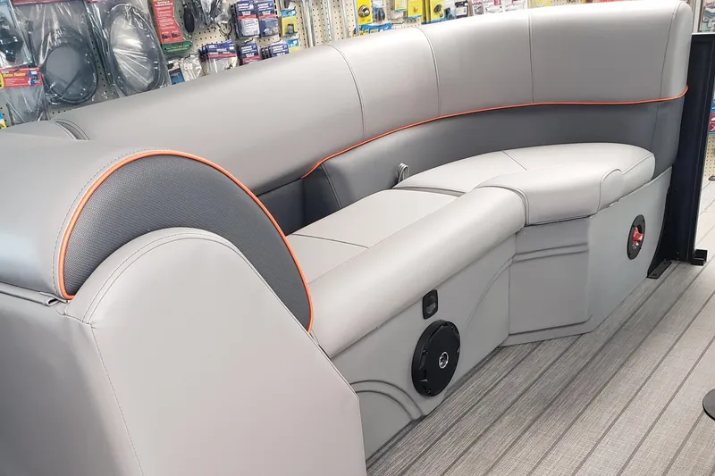 Slide: The Image of 2025 Bentley Pontoons Legacy Navigator interior with gray seating and orange accents. - 5