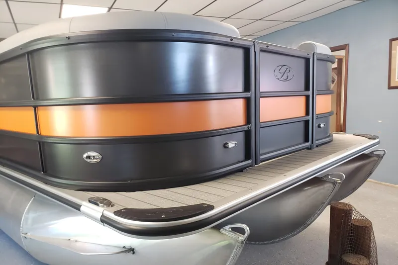 Slide: The Image of 2025 Bentley Pontoons Legacy Navigator with sleek design and modern features in showroom. - 7