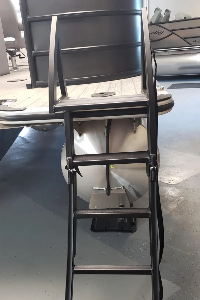 Slide: The Image of 2025 Bentley Pontoons Legacy Navigator with rear boarding ladder in showroom. - 8