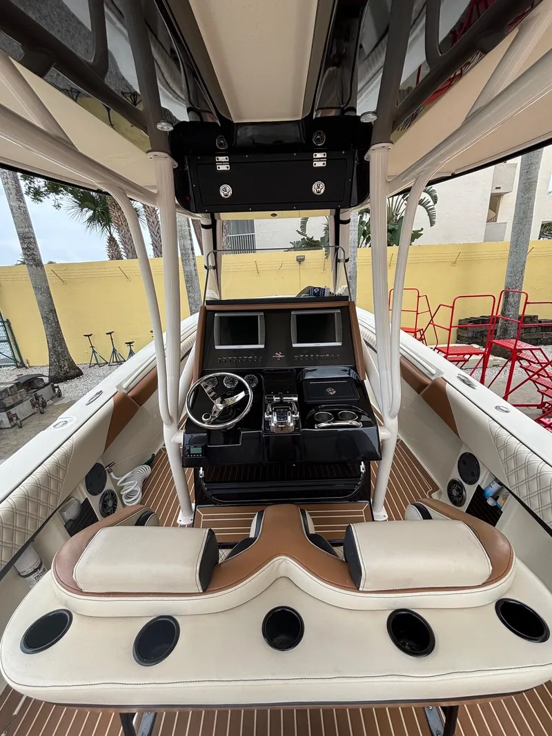 Slide: The Image of 2013 Statement 35 Center Console boat interior with dual screens and steering wheel. - 10