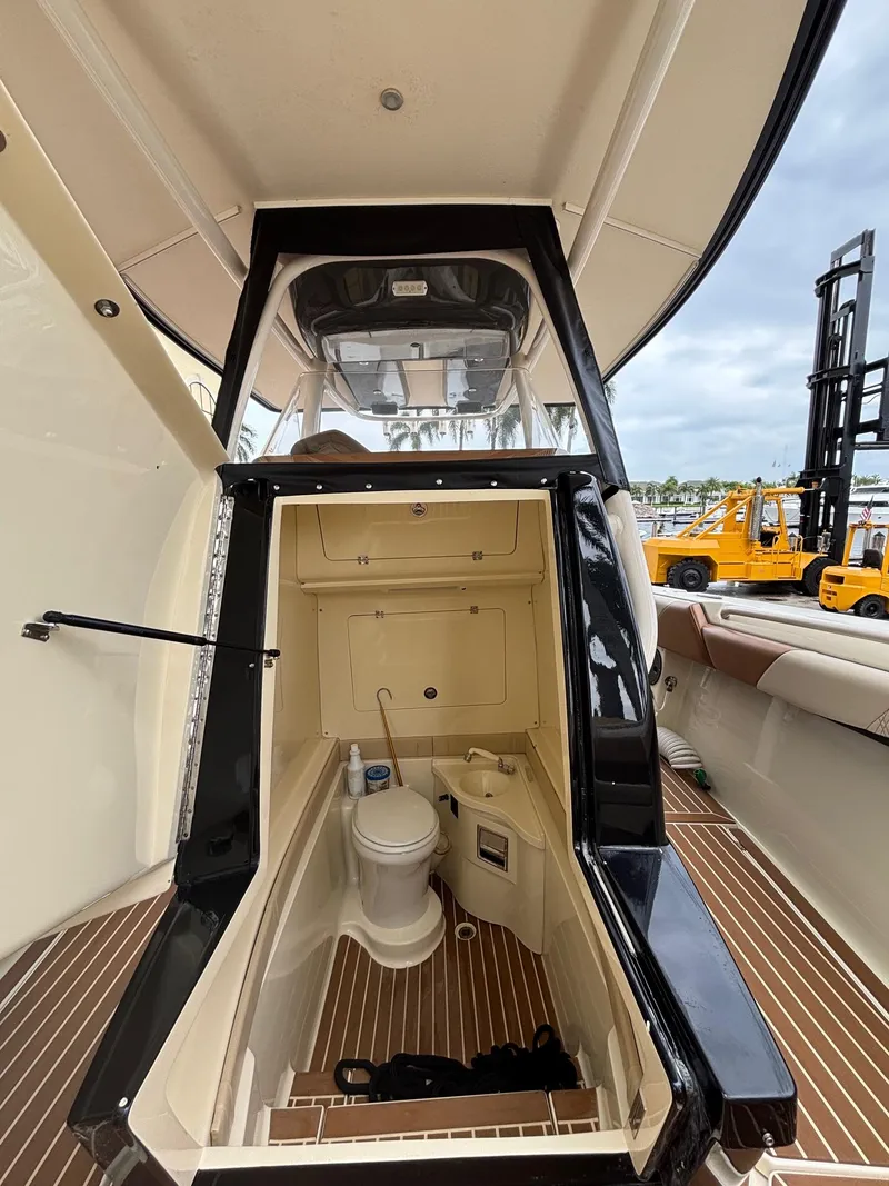 Slide: The Image of 2013 Statement 35 Center Console boat interior with toilet and storage compartment. - 15