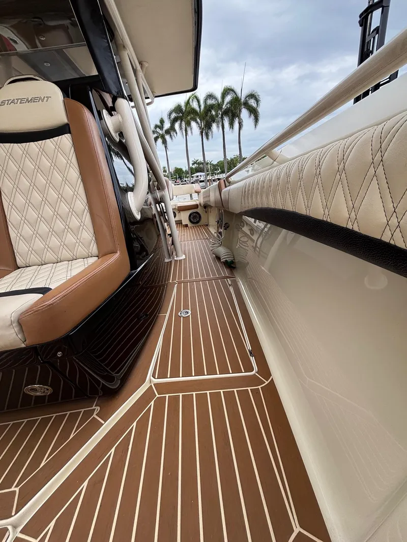 Slide: The Image of Luxurious 2013 Statement 35 Center Console boat interior with elegant seating and wood-patterned flooring. - 16