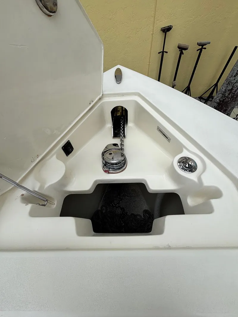 Slide: The Image of Anchor compartment of 2013 Statement 35 Center Console boat, featuring winch and chain storage. - 18