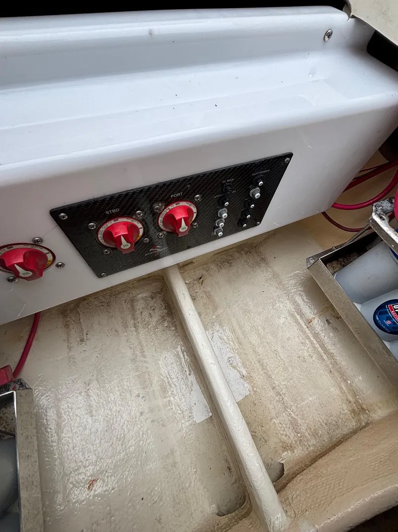 Slide: The Image of Control panel of 2013 Statement 35 Center Console boat with red switches and wiring. - 21