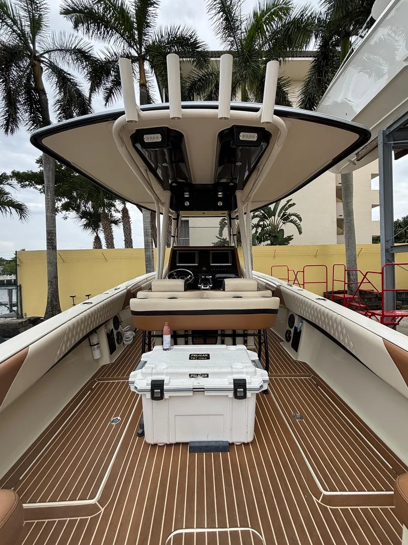 Slide: The Image of 2013 Statement 35 Center Console boat with teak flooring and palm trees in the background. - 23