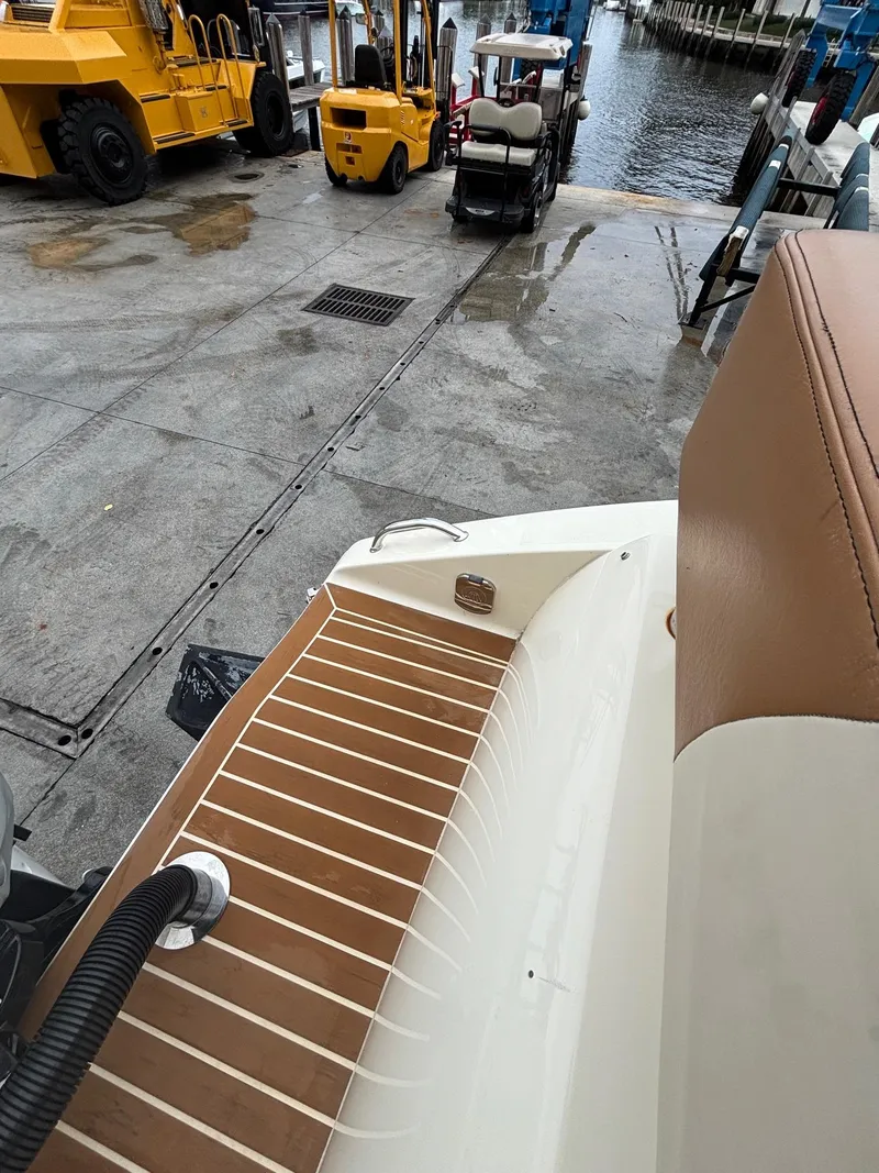 Slide: The Image of 2013 Statement 35 Center Console boat at dock with forklifts and water view. - 25