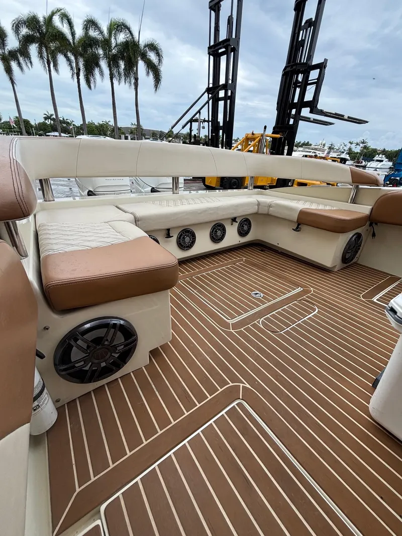 Slide: The Image of Luxurious 2013 Statement 35 Center Console boat interior with cushioned seating and speakers. - 28