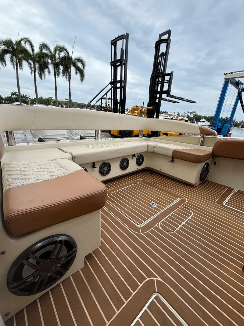 Slide: The Image of Luxurious 2013 Statement 35 Center Console boat interior with plush seating and wood-patterned flooring. - 29