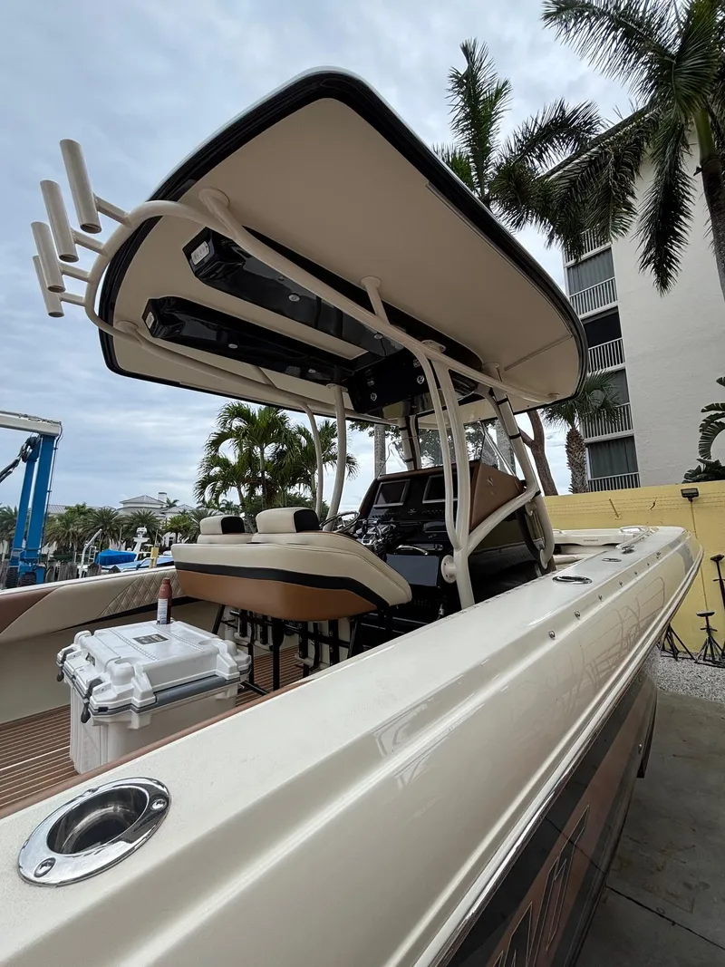 Slide: The Image of 2013 Statement 35 Center Console boat with T-top, docked near palm trees. - 33