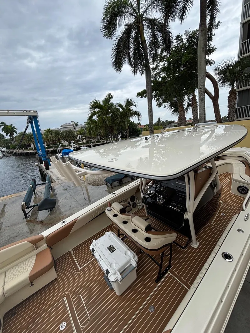 Slide: The Image of 2013 Statement 35 Center Console boat docked, featuring sleek design and spacious deck. - 9