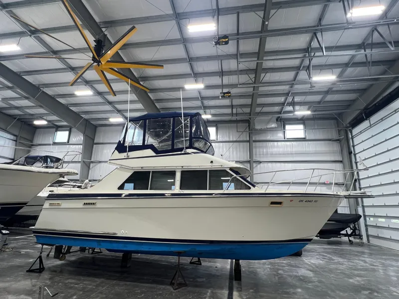 Slide: The Image of 1987 Tollycraft 30 Sport Cruiser in a spacious indoor storage facility. - 0