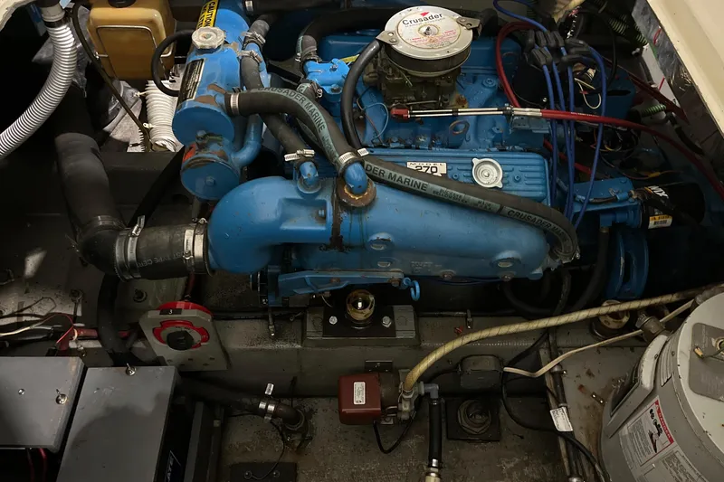 Slide: The Image of Engine compartment of a 1987 Tollycraft 30 Sport Cruiser, featuring a blue marine engine. - 20
