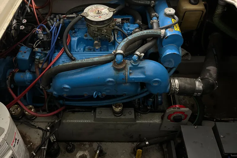 Slide: The Image of Engine of 1987 Tollycraft 30 Sport Cruiser, featuring blue marine components and hoses. - 21