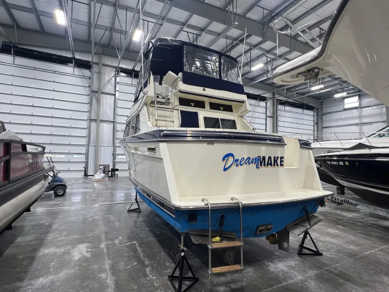 Slide: The Image of 1987 Tollycraft 30 Sport Cruiser in storage, rear view, with "Dream Maker" name. - 3