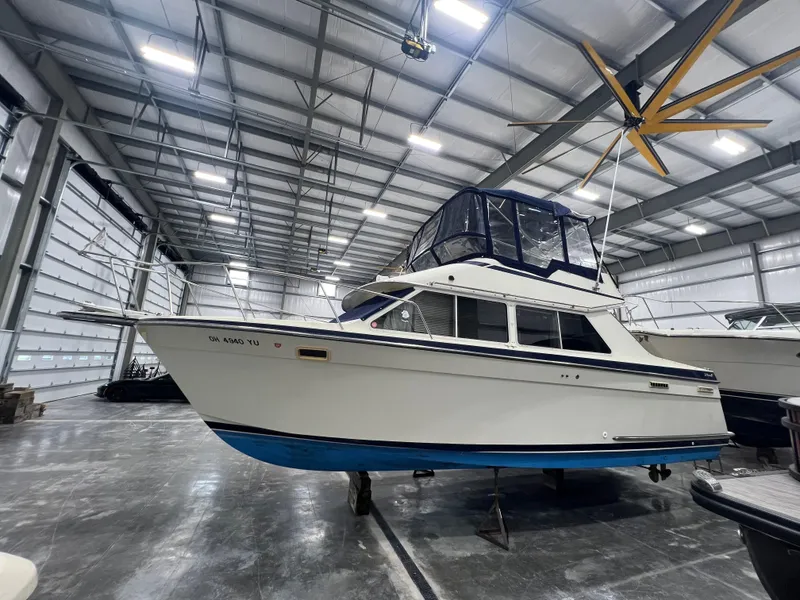 Slide: The Image of 1987 Tollycraft 30 Sport Cruiser in a spacious indoor storage facility. - 4