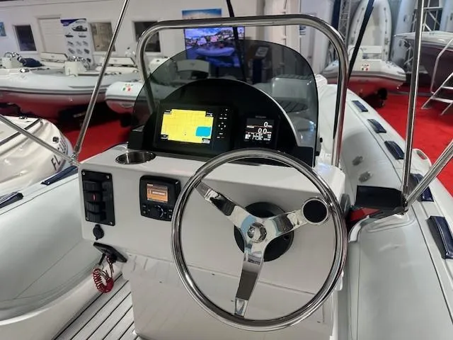 Slide: The Image of 2023 Tiger Marine SL 480 boat dashboard with steering wheel and navigation display. - 4