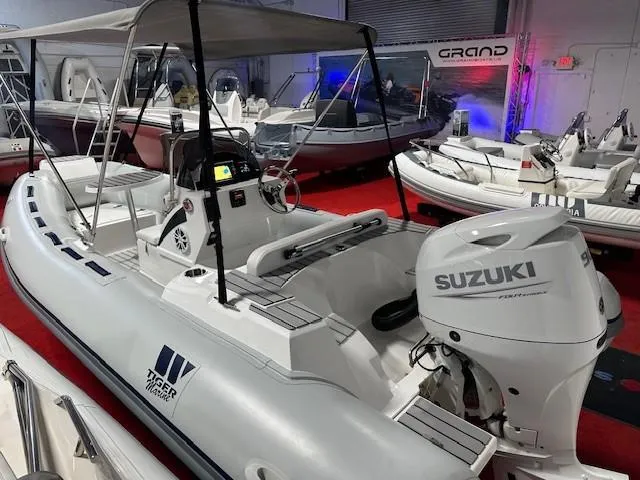 Slide: The Image of 2023 Tiger Marine SL 480 boat with Suzuki engine in showroom display. - 5