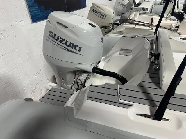 Slide: The Image of 2023 Tiger Marine SL 480 boat with Suzuki outboard motor in showroom. - 7