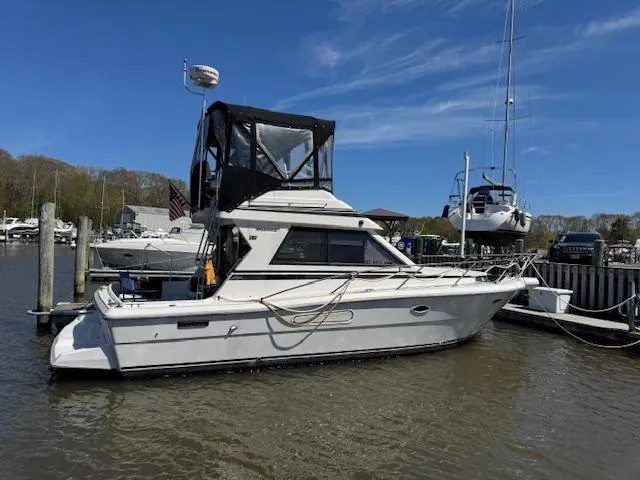 Slide: The Image of 1990 Tarrab 331 yacht docked at marina under clear blue sky. - 3