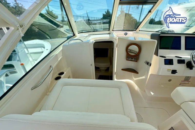 Slide: The Image of 2025 Grady-White Freedom 325 boat interior with helm and cabin view. - 11
