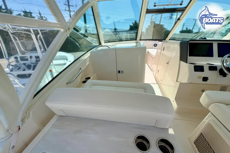 Slide: The Image of 2025 Grady-White Freedom 325 boat interior with helm and seating area. - 13