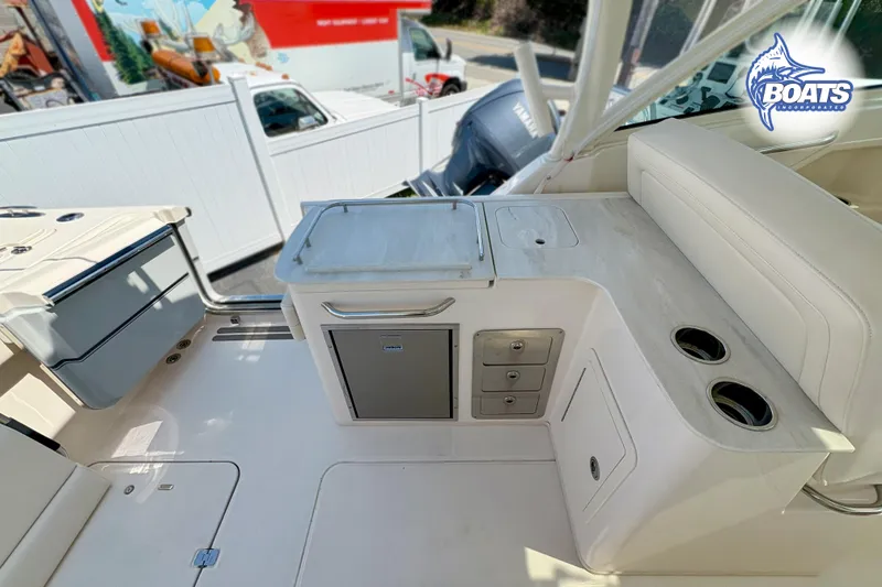 Slide: The Image of 2025 Grady-White Freedom 325 boat interior with seating, storage, and cup holders. - 15