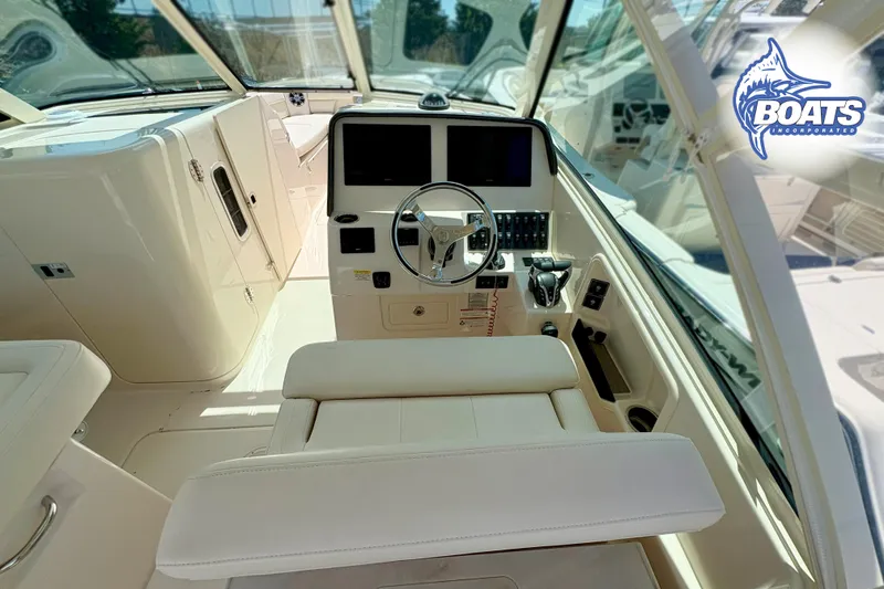 Slide: The Image of 2025 Grady-White Freedom 325 boat interior with modern helm and controls. - 8