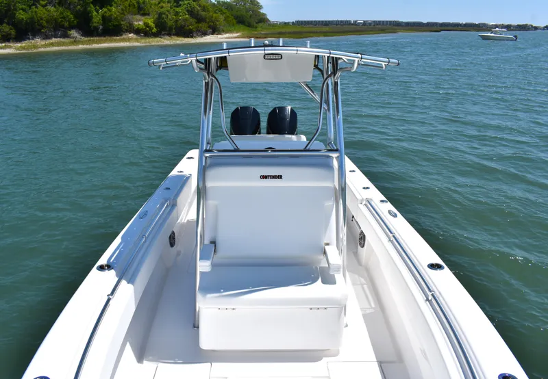 Slide: The Image of 2024 Contender 28 Tournament boat on calm water, featuring sleek design and dual engines. - 10