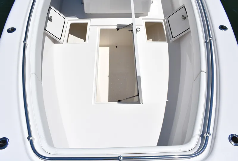 Slide: The Image of 2024 Contender 28 Tournament boat deck with open storage compartments. - 11