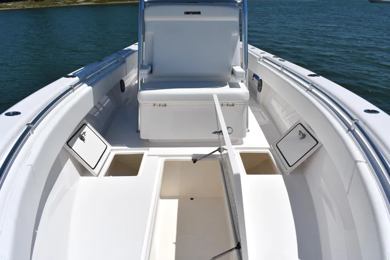 Slide: The Image of 2024 Contender 28 Tournament boat interior with storage compartments and seating on calm water. - 12