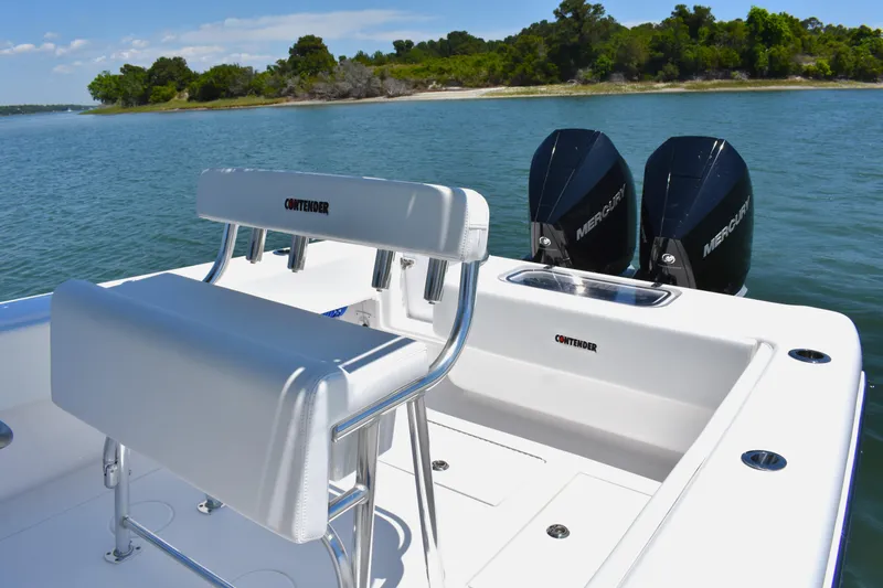 Slide: The Image of 2024 Contender 28 Tournament boat with dual Mercury engines on a serene water backdrop. - 14