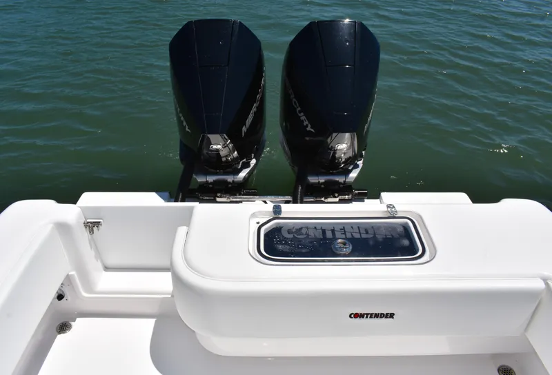Slide: The Image of 2024 Contender 28 Tournament boat with dual outboard motors on water. - 15