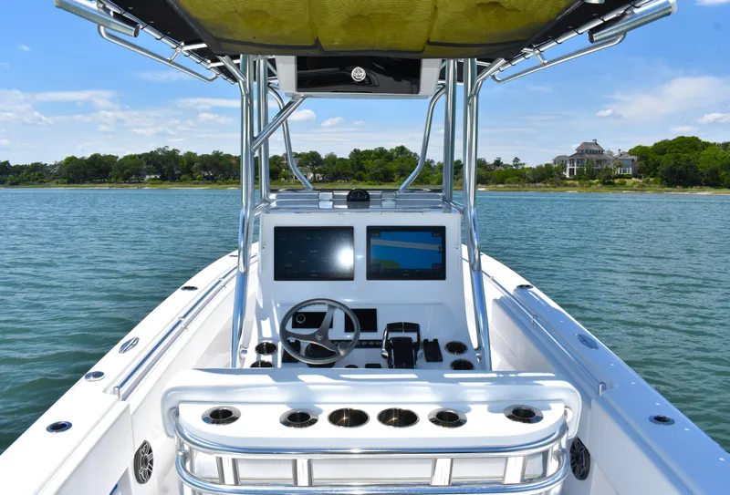 Slide: The Image of 2024 Contender 28 Tournament boat dashboard with dual screens on calm water. - 17