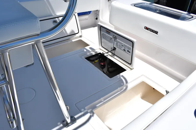Slide: The Image of 2024 Contender 28 Tournament boat interior with open storage compartments and seating. - 21
