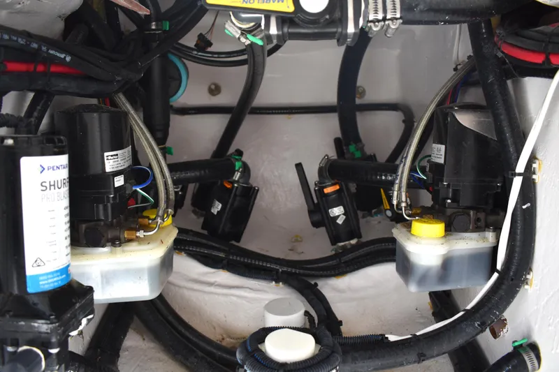 Slide: The Image of 2024 Contender 28 Tournament boat engine compartment with wiring and components. - 24