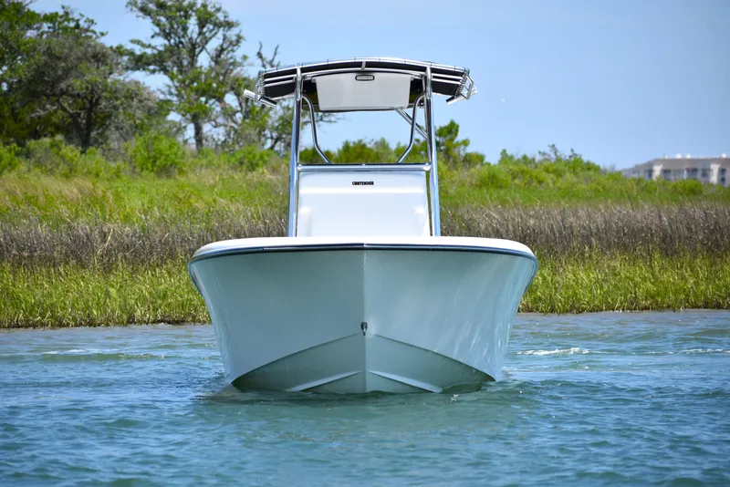 Slide: The Image of 2024 Contender 28 Tournament boat on water, front view, with lush greenery background. - 7