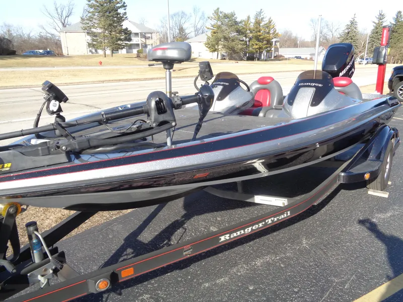 Slide: The Image of 2007 Ranger 188DVS boat on trailer, parked outdoors, with fishing equipment visible. - 10