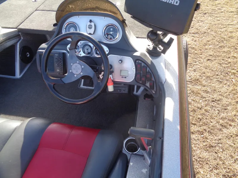 Slide: The Image of 2007 Ranger 188DVS boat cockpit with steering wheel, gauges, and red-black seating. - 14