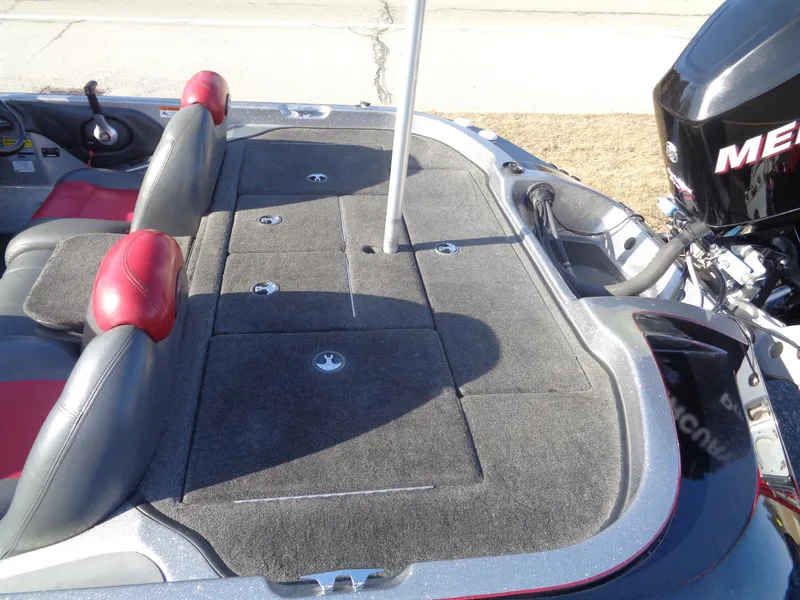 Slide: The Image of 2007 Ranger 188DVS boat interior with red and gray seating, carpeted deck, and Mercury engine. - 6