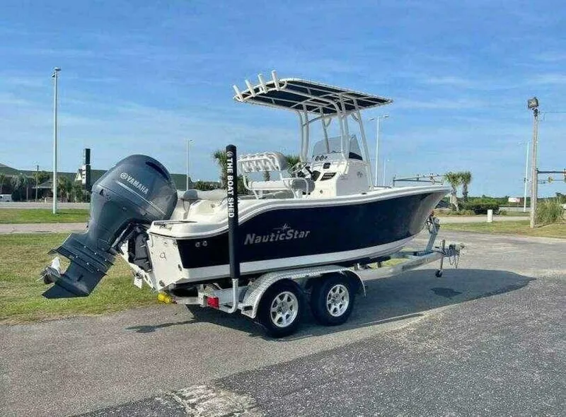 The Image of 2022 NauticStar 2102 Legacy boat on trailer with Yamaha outboard motor. - 0