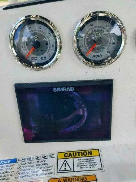 Slide: The Image of Dashboard of 2022 NauticStar 2102 Legacy boat with gauges and Simrad display. - 18