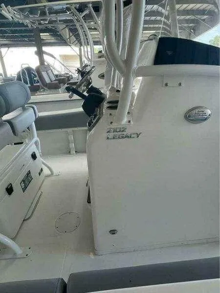 Slide: The Image of 2022 NauticStar 2102 Legacy boat interior with seating and steering console. - 20