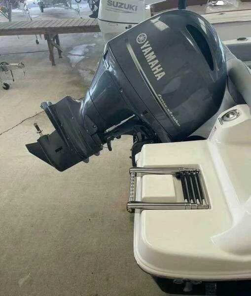 Slide: The Image of 2022 NauticStar 2102 Legacy boat with Yamaha outboard motor in a showroom. - 4