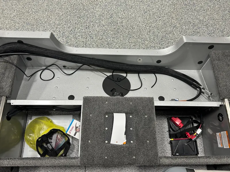 Slide: The Image of 2024 Alumacraft Classic 165 Sport interior showing storage compartments and wiring setup. - 12