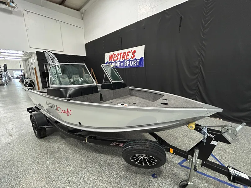 Slide: The Image of 2024 Alumacraft Classic 165 Sport boat on display in showroom. - 2