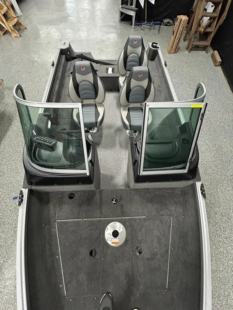 Slide: The Image of 2024 Alumacraft Classic 165 Sport boat interior with seating and windshield, viewed from above. - 8