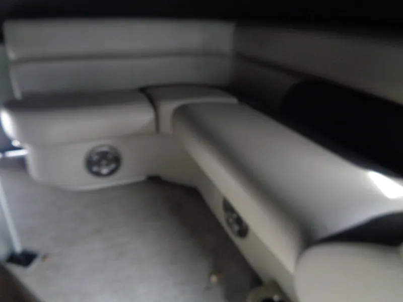 Slide: The Image of 2022 Premier 210 Sunspree pontoon boat with black cover, parked outdoors. - 10