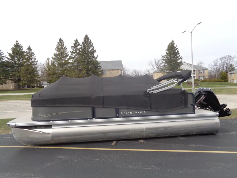 Slide: The Image of 2022 Premier 210 Sunspree pontoon boat with cover, parked on a street. - 19